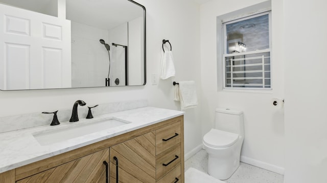 bathroom featuring toilet, walk in shower, and vanity