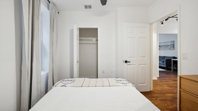 bedroom with ceiling fan, dark hardwood / wood-style flooring, and a closet