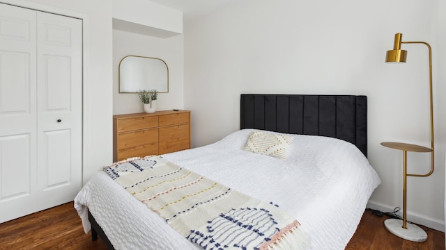 bedroom featuring a closet and dark hardwood / wood-style floors