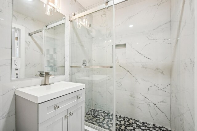 98 Van Horne St Unit A, Jersey City, NJ 07304 - bathroom with tile walls, vanity, and a marble finish shower