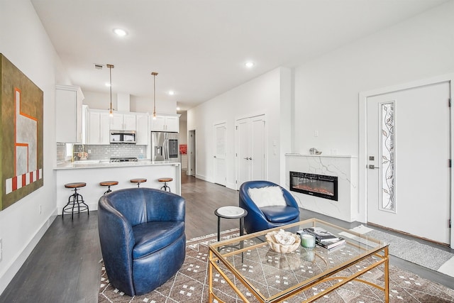 98 Van Horne St Unit A, Jersey City, NJ 07304 - living area with baseboards, a fireplace, recessed lighting, and dark wood-style flooring