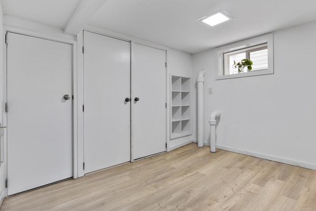 179 W 8th St, Bayonne, NJ 07002 - unfurnished bedroom featuring light wood-style floors, a closet, and beamed ceiling