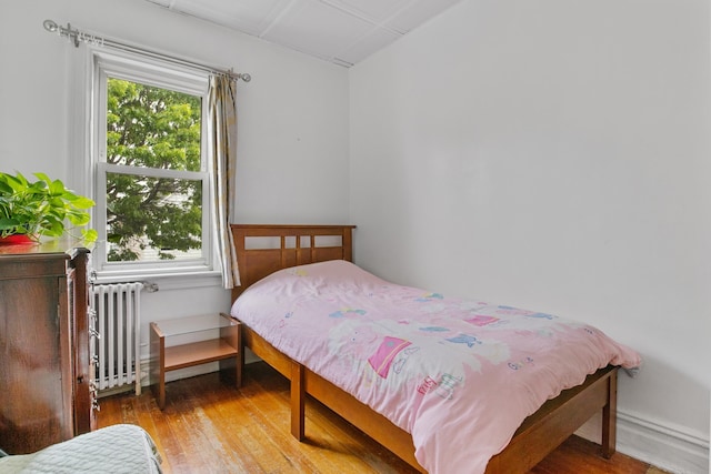 179 W 8th St, Bayonne, NJ 07002 - bedroom with radiator and wood finished floors