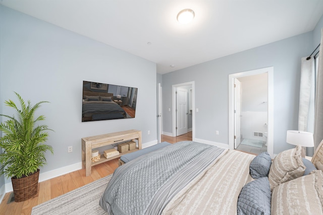 31 Ravine Ave Unit 1, Jersey City, NJ 07307 - bedroom with light wood-style floors, baseboards, and ensuite bathroom
