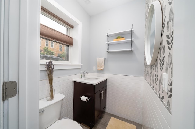 31 Ravine Ave Unit 1, Jersey City, NJ 07307 - bathroom featuring tile walls, toilet, vanity, and wainscoting