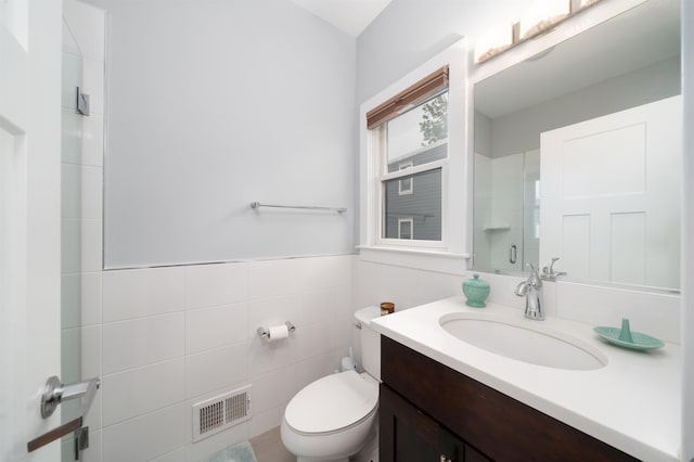 31 Ravine Ave Unit 1, Jersey City, NJ 07307 - full bath featuring tile walls, vanity, toilet, and a shower with door