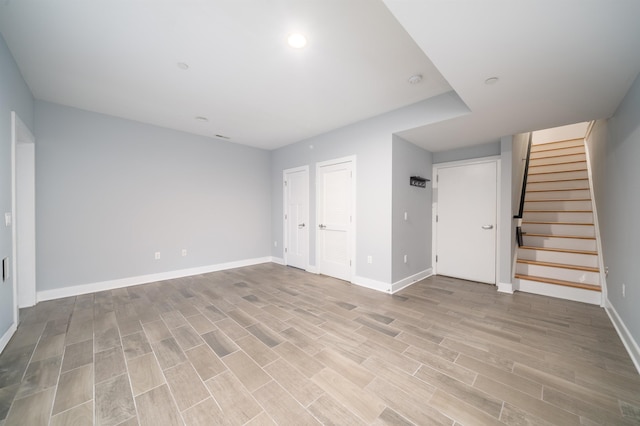 31 Ravine Ave Unit 1, Jersey City, NJ 07307 - unfurnished living room with light wood-style floors, baseboards, stairway, and recessed lighting