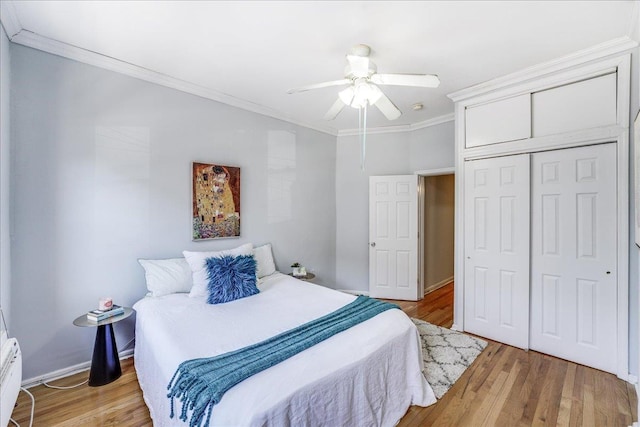 519 Willow Ave Unit 3, Hoboken, NJ 07030 - bedroom with crown molding, a closet, light wood-style floors, a ceiling fan, and baseboards