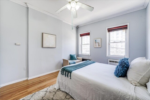 519 Willow Ave Unit 3, Hoboken, NJ 07030 - bedroom with wood finished floors, crown molding, baseboards, ceiling fan, and a wall unit AC