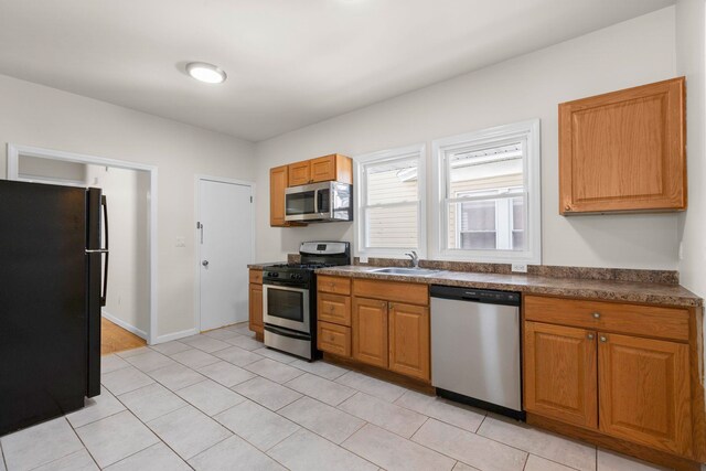 195 Stanley Pl, Hackensack, NJ 07601 - kitchen featuring stainless steel appliances, dark countertops, and brown cabinets