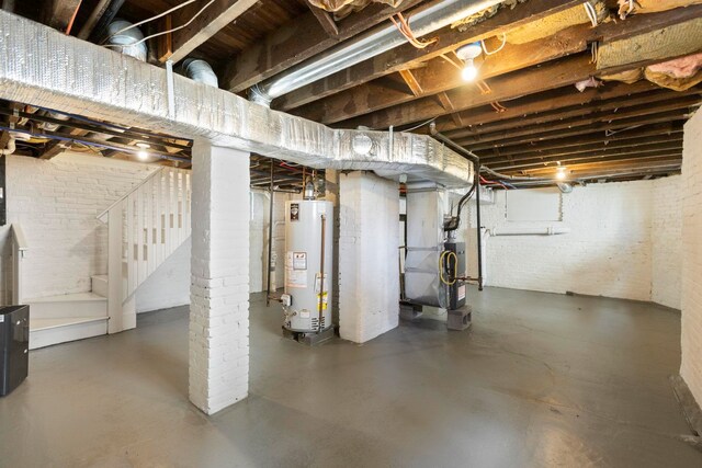 195 Stanley Pl, Hackensack, NJ 07601 - unfinished below grade area featuring water heater, brick wall, stairs, and heating unit