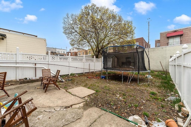 914 19th St, Union City, NJ 07087 - fenced backyard with a trampoline and a patio area