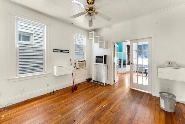 914 19th St, Union City, NJ 07087 - living area featuring radiator heating unit, wood-type flooring, ceiling fan, crown molding, and french doors