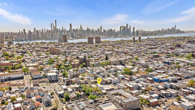 drone / aerial view featuring a city view and a water view