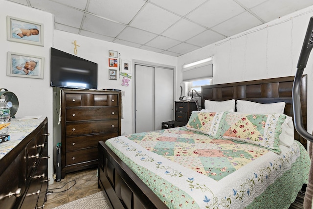 bedroom featuring a closet and a drop ceiling