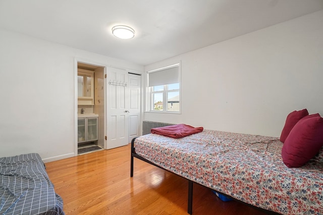 1224 80th St, North Bergen, NJ 07047 - bedroom featuring radiator, wood finished floors, a closet, and ensuite bath