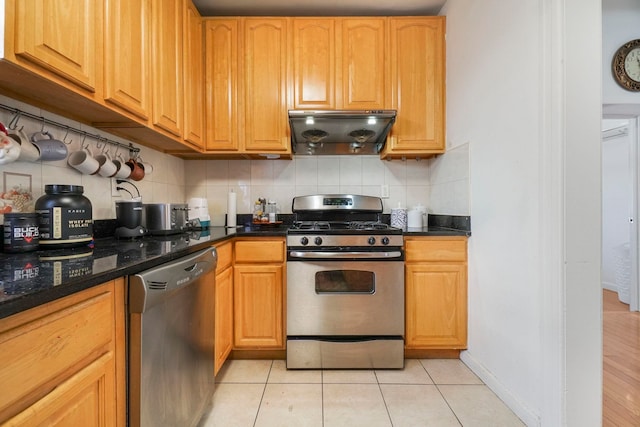1224 80th St, North Bergen, NJ 07047 - kitchen featuring appliances with stainless steel finishes, under cabinet range hood, backsplash, and light tile patterned flooring