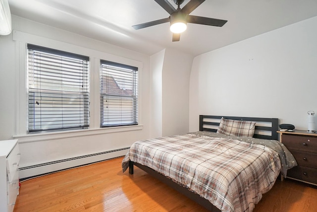 1224 80th St, North Bergen, NJ 07047 - bedroom featuring baseboard heating, wood finished floors, and ceiling fan