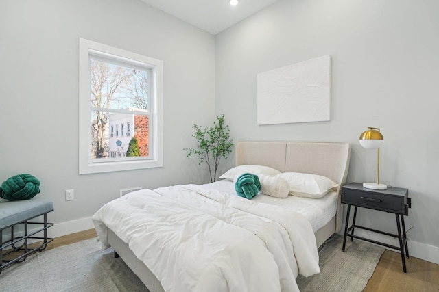 bedroom with hardwood / wood-style flooring