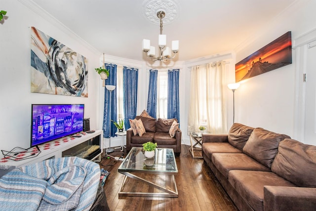 living room featuring ornamental molding, a notable chandelier, and dark hardwood / wood-style flooring