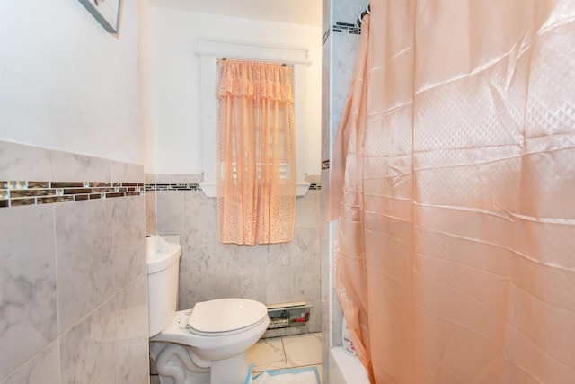 bathroom with shower / bathtub combination with curtain, toilet, and tile walls