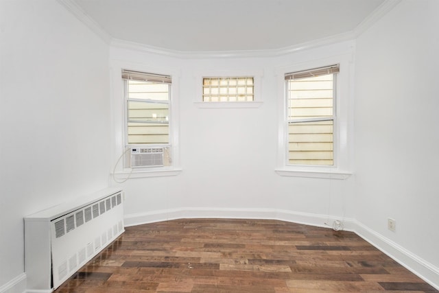 spare room with crown molding, radiator, cooling unit, and dark hardwood / wood-style floors