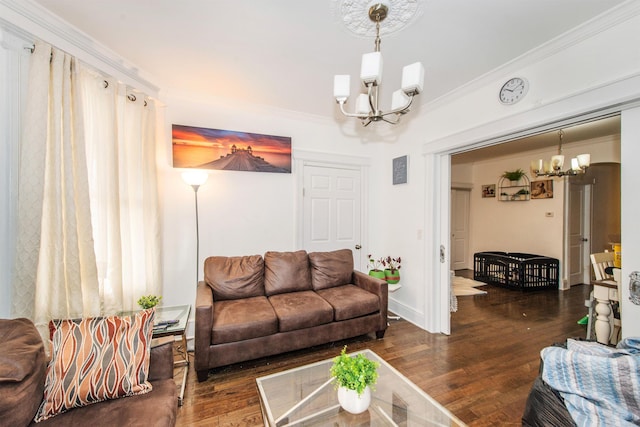 living room with dark hardwood / wood-style flooring, ornamental molding, and a chandelier