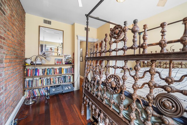 352 7th St Unit 3, Jersey City, NJ 07302 - hallway with brick wall and hardwood / wood-style floors