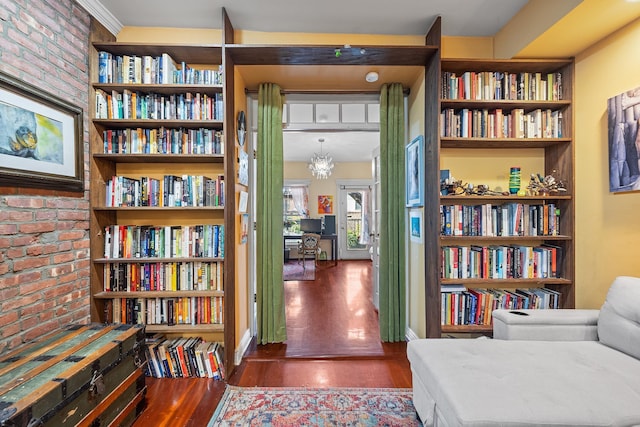 352 7th St Unit 3, Jersey City, NJ 07302 - sitting room with brick wall, wood finished floors, and bookshelves