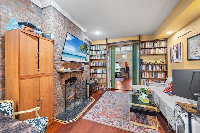 352 7th St Unit 3, Jersey City, NJ 07302 - living room with wood finished floors, a brick fireplace, crown molding, recessed lighting, and brick wall