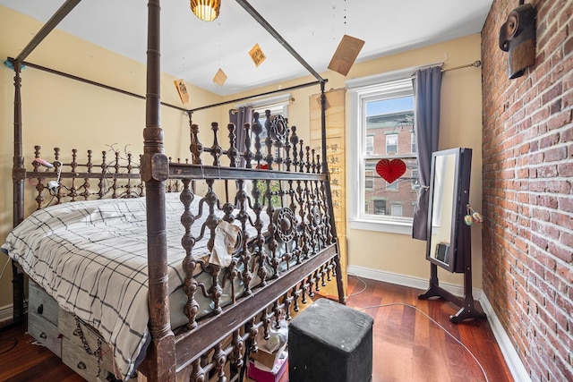 352 7th St Unit 3, Jersey City, NJ 07302 - bedroom with brick wall and wood finished floors