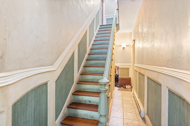 352 7th St Unit 3, Jersey City, NJ 07302 - stairway with a wainscoted wall, a decorative wall, and tile patterned flooring