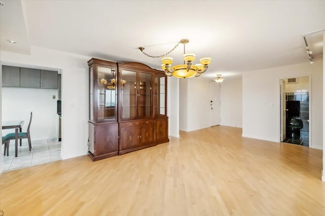 300 Winston Dr # 1822, Cliffside Park, NJ 07010 - unfurnished living room featuring a chandelier and light wood-type flooring