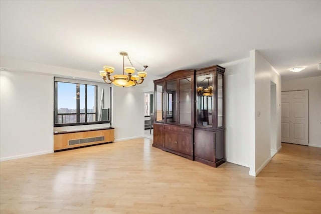 300 Winston Dr # 1822, Cliffside Park, NJ 07010 - unfurnished dining area featuring a chandelier, light wood-style floors, and radiator heating unit