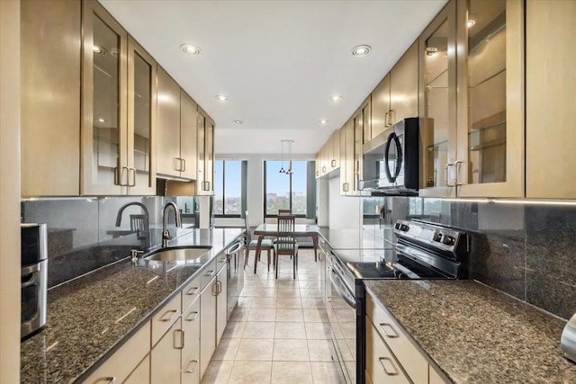 300 Winston Dr # 1822, Cliffside Park, NJ 07010 - kitchen with stainless steel appliances, tasteful backsplash, recessed lighting, light tile patterned floors, and glass insert cabinets