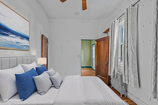 300 2nd St Unit 2, Jersey City, NJ 07302 - bedroom featuring radiator, light wood-style floors, and ceiling fan