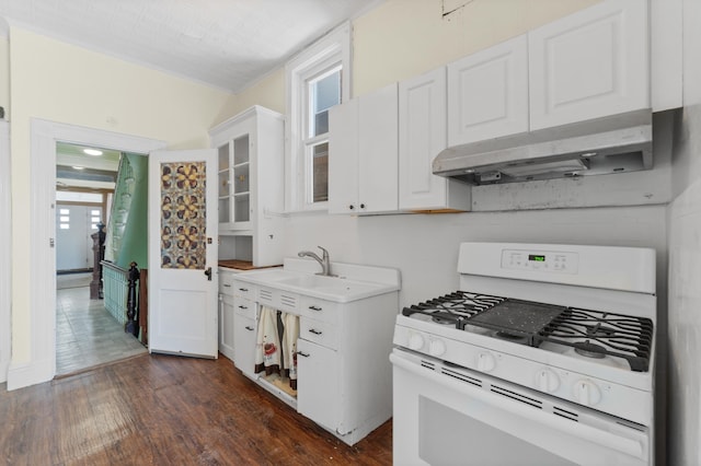 572 Gregory Ave, Weehawken, NJ 07086 - kitchen with white gas range oven, under cabinet range hood, white cabinets, dark wood-style flooring, and glass insert cabinets