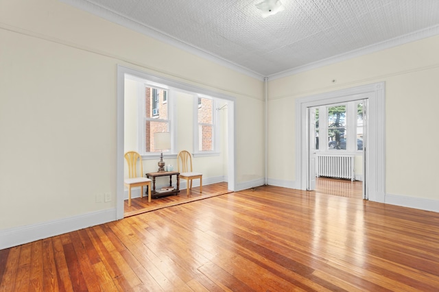 572 Gregory Ave, Weehawken, NJ 07086 - unfurnished room featuring radiator heating unit and hardwood / wood-style flooring