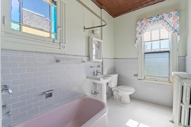 572 Gregory Ave, Weehawken, NJ 07086 - full bath featuring radiator heating unit, a wainscoted wall, a tub, and tile walls