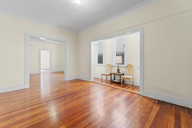 unfurnished room with hardwood / wood-style flooring and baseboards