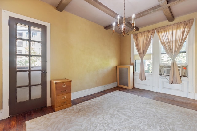 interior space featuring a healthy amount of sunlight, a chandelier, wood-type flooring, and coffered ceiling