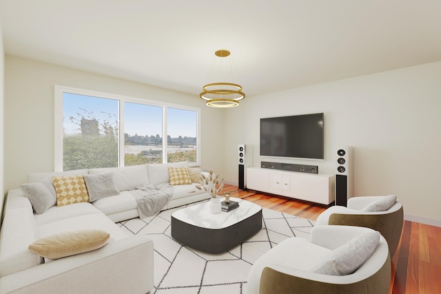 living room with a chandelier and light wood-style flooring