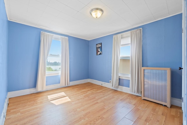 unfurnished room featuring wood finished floors and baseboards