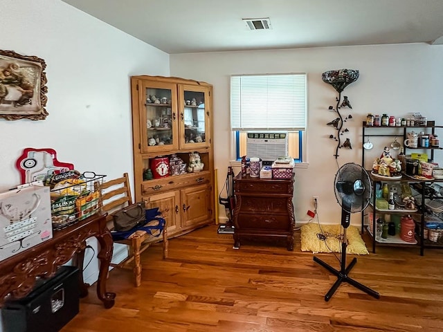 interior space with cooling unit and dark hardwood / wood-style flooring