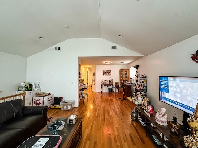 living room with light hardwood / wood-style floors and lofted ceiling