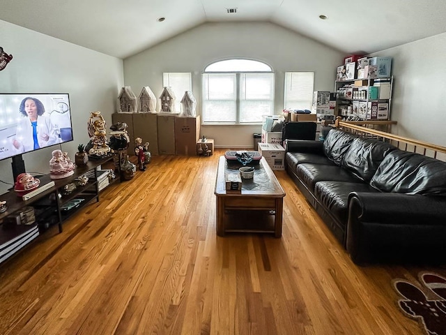 living room featuring light wood-type flooring and lofted ceiling