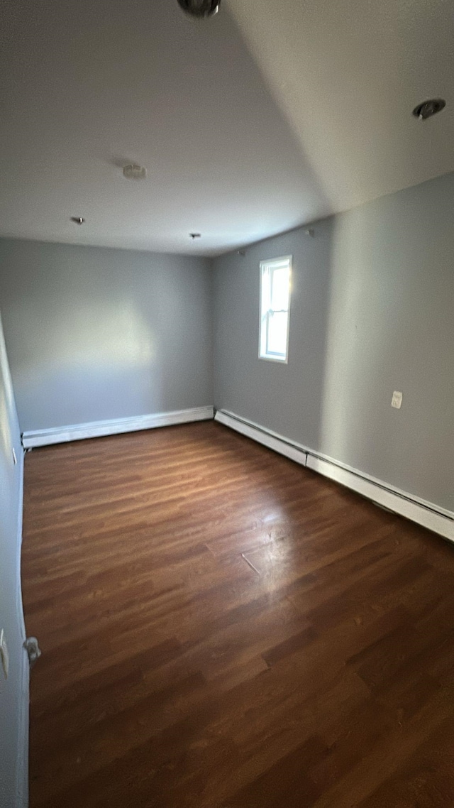 79 W 18th St, Bayonne, NJ 07002 - unfurnished room featuring a baseboard radiator and dark wood finished floors