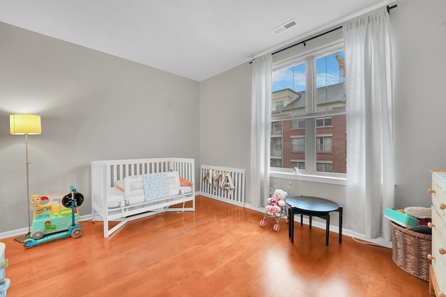 26 Ave At Port Imperial Unit 133, West New York, NJ 07093 - bedroom featuring wood finished floors and a nursery area