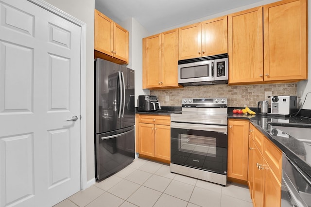 26 Ave At Port Imperial Unit 133, West New York, NJ 07093 - kitchen with appliances with stainless steel finishes, light tile patterned floors, backsplash, and dark stone counters