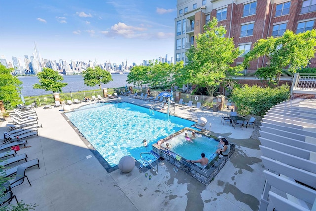 26 Ave At Port Imperial Unit 133, West New York, NJ 07093 - community pool featuring a patio area, a hot tub, and a view of skyline